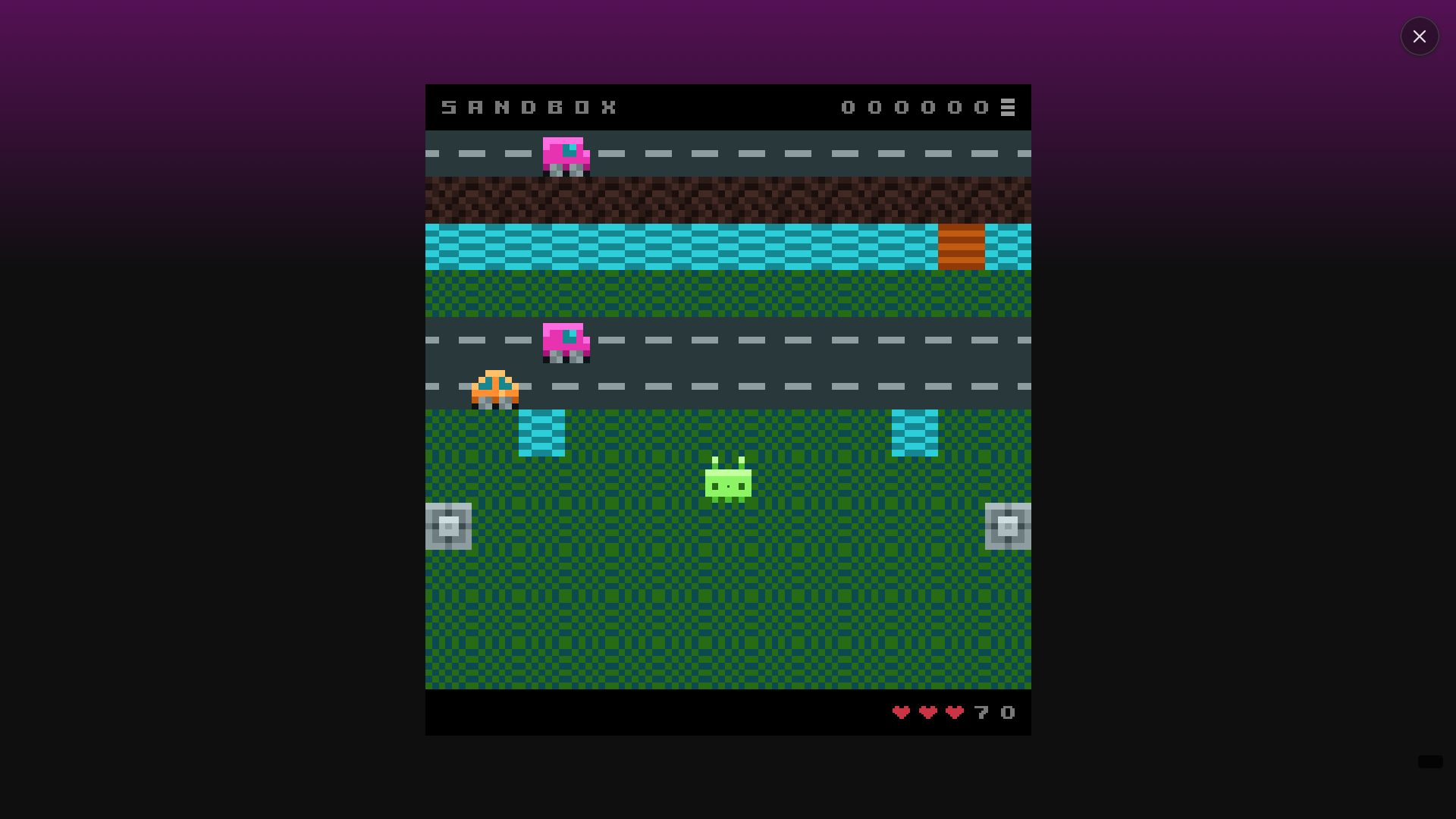 Screenshot of the Sample Game 'Fragger' in action. A little green alien is in the center of the screen, in a grassy field just below a road and a river. It is a Frogger clone.